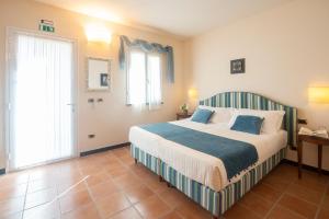 Postel nebo postele na pokoji v ubytování Hotel Al Terra Di Mare