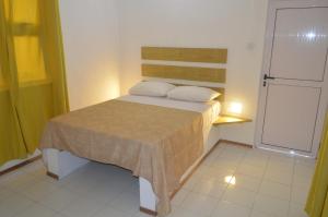 a small bedroom with a bed with two pillows at Bluestar Appartement 4, centre de Grand Baie in Grand Baie
