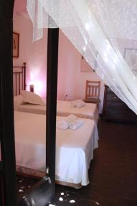 two beds in a room with a tent at Cortijo Torreblanca - 12 personas in Almería