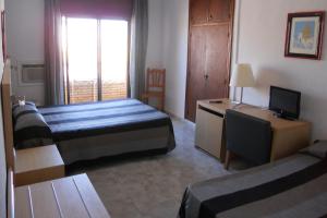 Säng eller sängar i ett rum på Hotel Sacratif