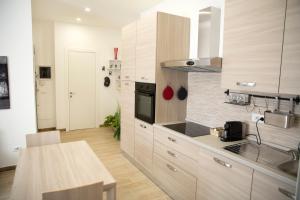 a kitchen with wooden cabinets and a counter top at JN holiday home in Rome