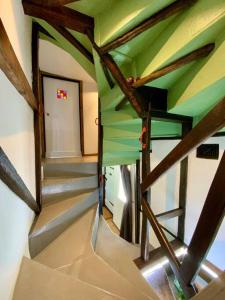 a view of a staircase in a house with a green ceiling at Beautiful 500 year old listed Kentish cottage in Wingham
