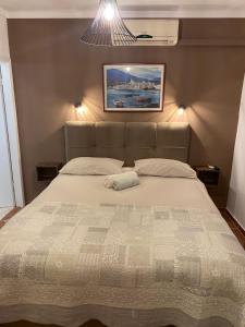 a bed in a bedroom with a picture on the wall at Apartments Oliva in Poreč