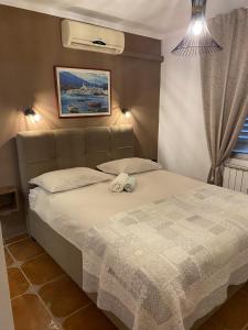 a bedroom with a bed with a white comforter at Apartments Oliva in Poreč