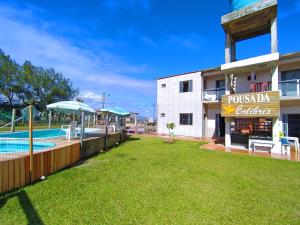 a resort with a swimming pool and a building at Pousada Colibris in Pinhal