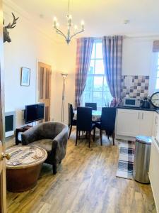 a living room with a couch and a table at Bailie Royal Mile Apartment in Edinburgh