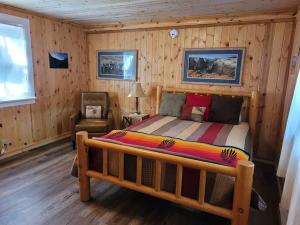 a bedroom with a bed in a wooden room at Free Spirit, Walking distance to East Zion trails in Orderville