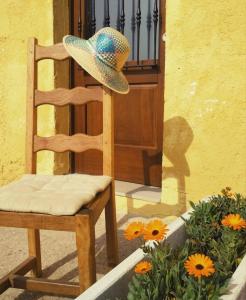 a hat sitting on a chair in front of a door at 643km landa etxea in Villatuerta +45 photos