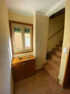 baño con escaleras, ventana y lavabo en Cals Piris Casa Rural, en Cabacés