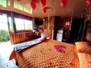 a bedroom with a large bed with red balloons in it at Cabañas Cerro Verde Lodge y Spa in Cartago