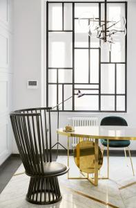 a table and chairs in a room at No.4 Residence in Warsaw