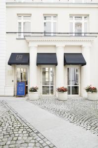 a white building with a black awning on it at No.4 Residence in Warsaw