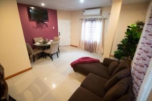 a living room with a couch and a table at Stacys Place #1 2 Bedroom Apartment in Port-of-Spain