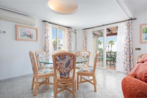 a dining room with a glass table and chairs at NEW! Villa Cala Marsal Front Sea View, Pool, BBQ, AC free in Portocolom
