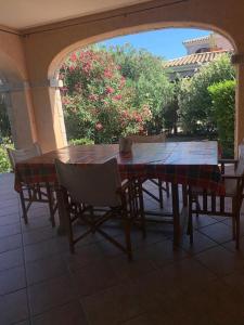 a wooden table and chairs on a patio at La Cinta in San Teodoro