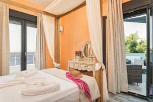 a bedroom with a bed with a mirror and a balcony at Villa Tania Samos in Samos