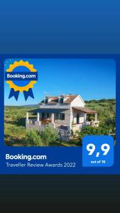 a picture of a house with the words booking com transfer review awards at Marina Holiday home in Postira
