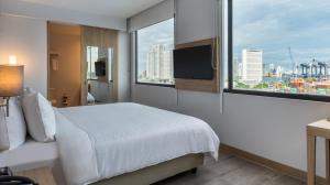 a hotel room with a bed and a large window at Holiday Inn Express Cartagena Manga by IHG in Cartagena de Indias +97 photos