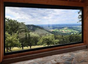 a window in a cabin looking out at a valley at Stein im Holz in Scheibbs