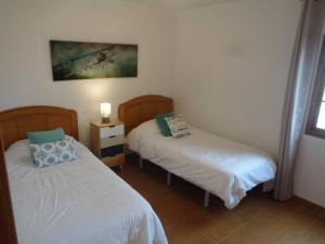sypialnia z 2 łóżkami i zdjęciem na ścianie w obiekcie Casa Ana Perez w mieście Antigua