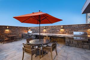 a table with an umbrella on a patio at Hyatt House Carlsbad in Carlsbad