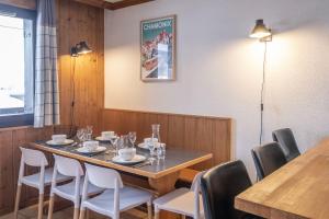 a dining room with a table and chairs at Appartement Les lutins - incredible view of Mont Blanc in Chamonix-Mont-Blanc