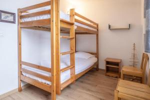 a bedroom with two bunk beds and a table at Appartement Les lutins - incredible view of Mont Blanc in Chamonix-Mont-Blanc
