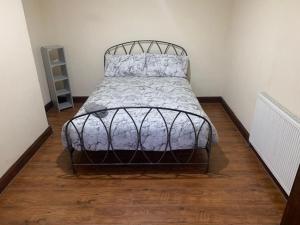 a bedroom with a bed with a metal frame at 3/4 Bedroom House in Manchester