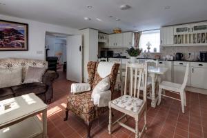 a kitchen and living room with a table and chairs at Katie's Cottage Bellaghy in Bellaghy