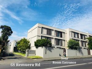 a white building on the side of a street at New Market Cozy Room in Auckland