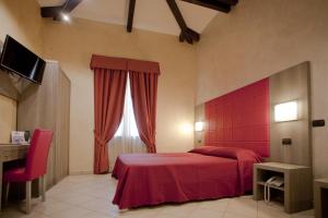 Postel nebo postele na pokoji v ubytování Hotel Villa Glicini