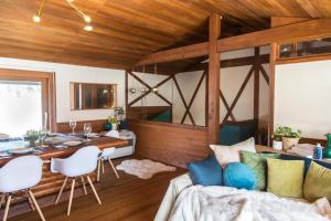 a living room with a couch and a table at Boutique Chalet sleeps 10 - Wasabi Wonderland in Myoko