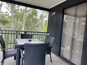 a patio with a table and chairs on a deck at Levi Adelaide Holiday Park in Adelaide
