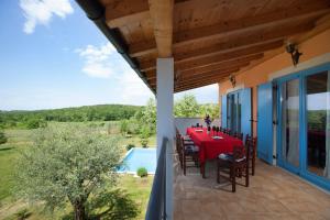 an external view of a house with a table and chairs at Relax in nature villa Mugeba Club in Poreč