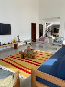 a living room with a couch and a table at Casa Beija Flor in Porto Seguro