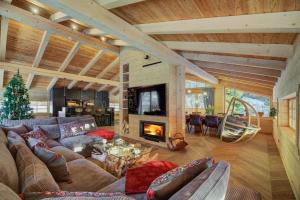 a living room with a couch and a fireplace at Pod Lasem in Krynica Zdrój