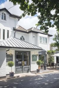 a store front of a white building at George Hotel, Best Western Signature Collection in Norwich