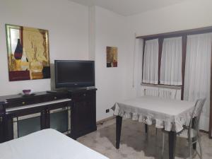 a living room with a tv and a table and a table and chairs at Dony's holiday homes CISE 15782 in Pontinia