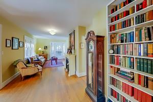 a living room with a large book shelf filled with books at Vintner's Cottage in Hendersonville