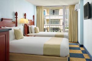 Postel nebo postele na pokoji v ubytování Ewa Hotel Waikiki