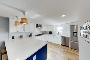 a kitchen with white cabinets and a white counter top at Sandyhill Sun in Ocean City