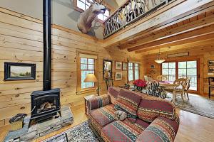 a living room with a couch and a fireplace at Elkhorn Cabin in Asheville