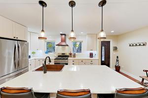 a large kitchen with a large white counter top at Dalton Abby Retreat in Black Mountain