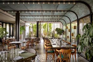 a restaurant with tables and chairs and windows at Fairmont Century Plaza Los Angeles at Beverly Hills in Los Angeles
