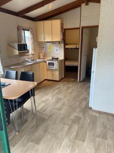 a kitchen with wooden floors and wooden cabinets at Victoria Lake Holiday Park in Shepparton