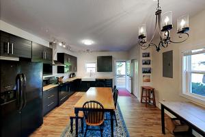 a kitchen with a wooden table and a dining room at Cool Springs Manor in Asheville