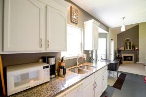 a kitchen with white cabinets and a sink and a stove at Music Escape in Nashville