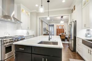 a large kitchen with white cabinets and a sink at Musician's Ranch in Franklin