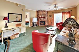 a living room with a red chair and a fireplace at Summit Manor Condos Unit B3062 in Gatlinburg