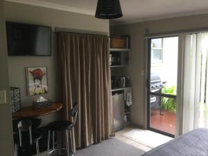 a bedroom with a sliding glass door to a patio at Sunrise suite in Collingwood